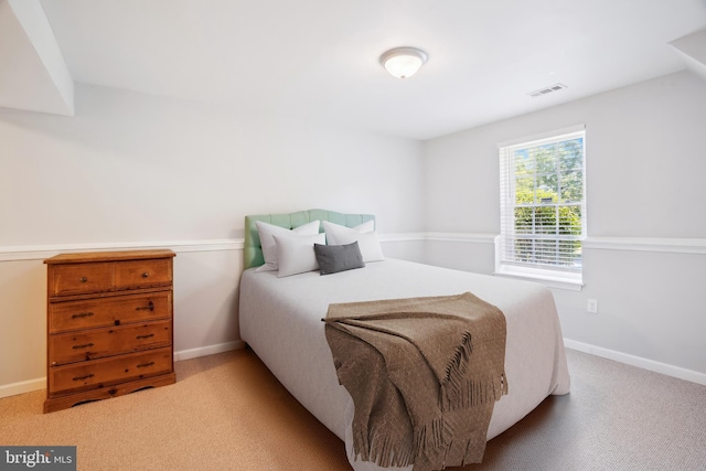 bedroom featuring visible vents, carpet, and baseboards