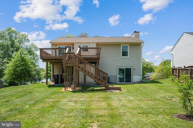 back of property with a wooden deck, fence, a chimney, a lawn, and stairway