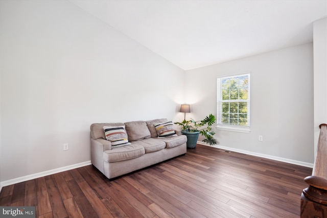 sitting room featuring baseboards, wood finished floors, and lofted ceiling