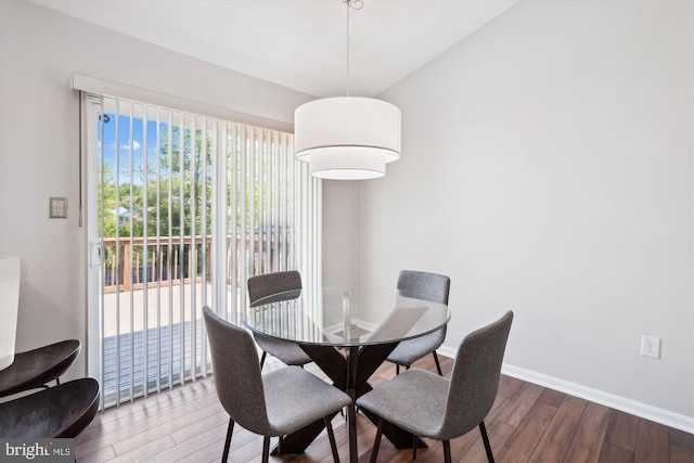 dining area with baseboards and wood finished floors