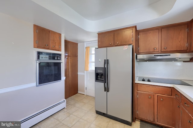 kitchen with brown cabinets, baseboard heating, wall oven, under cabinet range hood, and refrigerator with ice dispenser