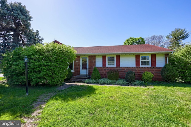 ranch-style home with brick siding and a front yard