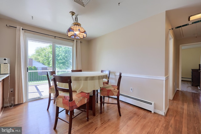 dining space featuring light wood-style floors, attic access, baseboard heating, and visible vents