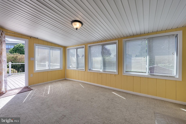 unfurnished sunroom with carpet and lofted ceiling