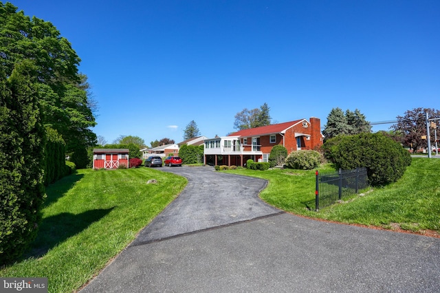 view of front of house with brick siding, fence, and a front yard