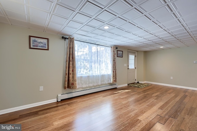 interior space with recessed lighting, baseboards, baseboard heating, and light wood-type flooring