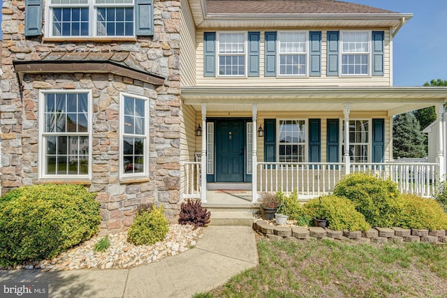 view of front facade featuring covered porch and stone siding