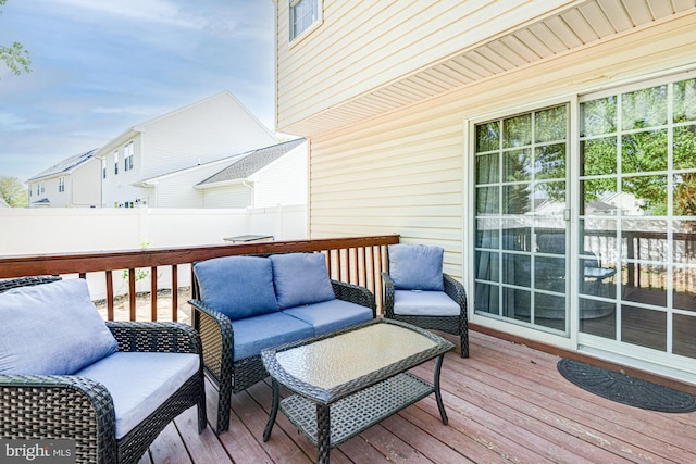 wooden terrace featuring fence and an outdoor hangout area
