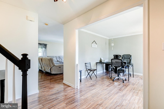 office space with baseboards, ornamental molding, and wood finished floors