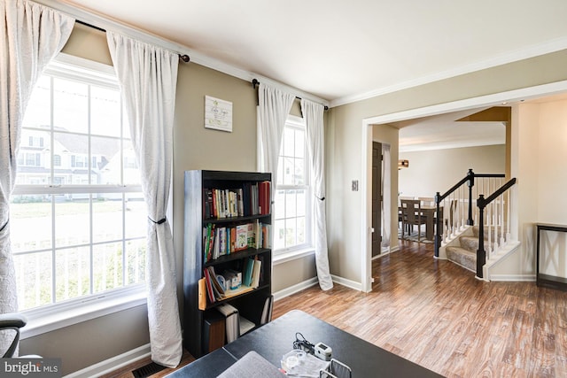 interior space with baseboards, visible vents, ornamental molding, and wood finished floors