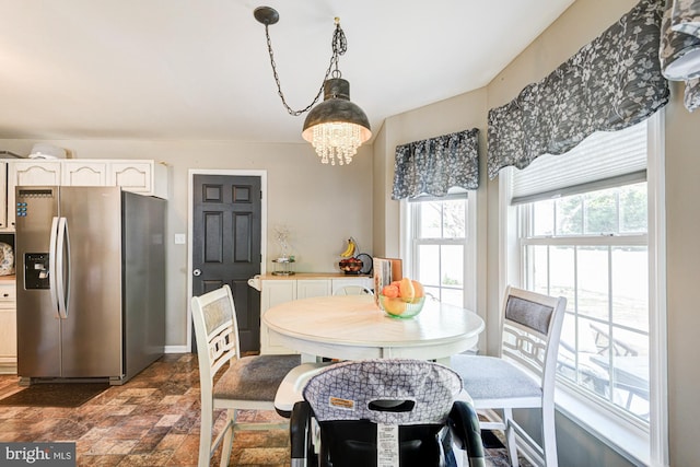dining room with baseboards and stone finish floor