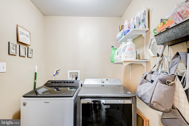 clothes washing area featuring washing machine and clothes dryer and laundry area