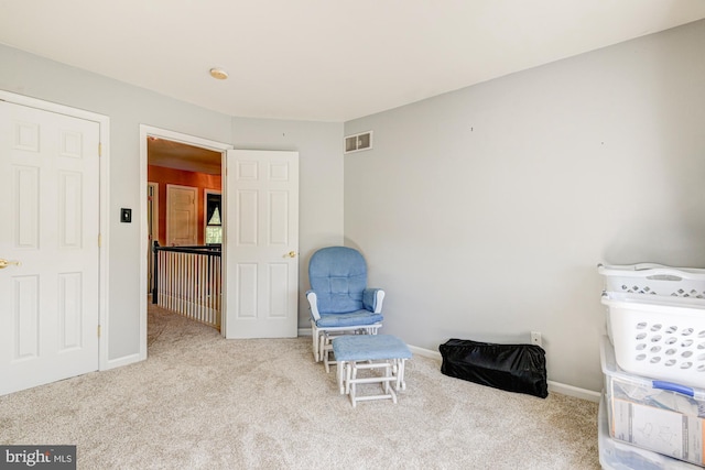 living area featuring baseboards, carpet flooring, and visible vents