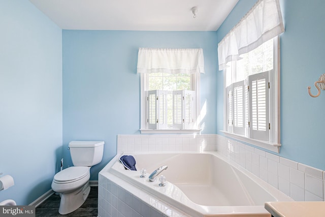full bathroom featuring toilet and a bath