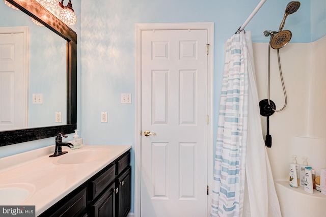 bathroom featuring double vanity, a sink, and a shower with curtain