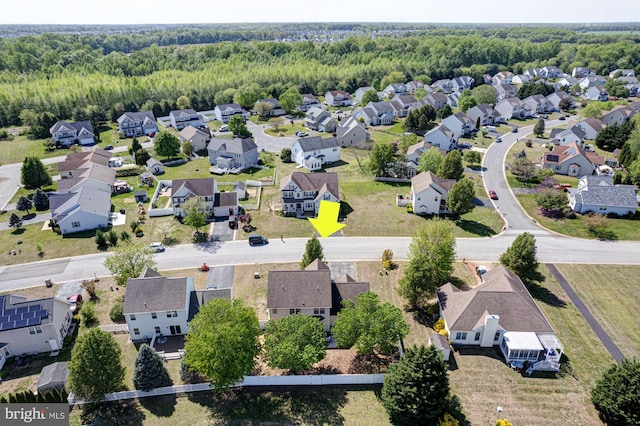 drone / aerial view with a residential view and a forest view