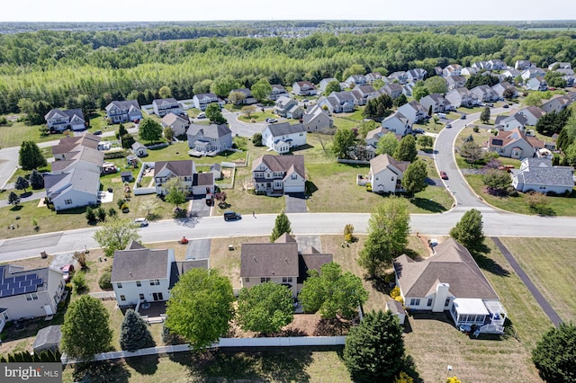 drone / aerial view with a residential view and a view of trees