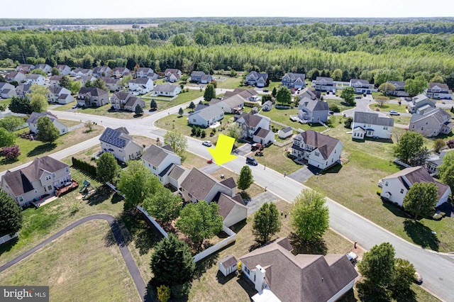 birds eye view of property featuring a view of trees and a residential view
