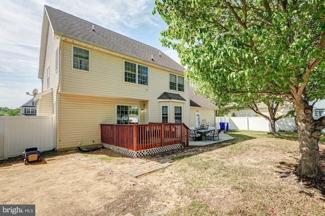 back of house with a patio, a fenced backyard, and a deck