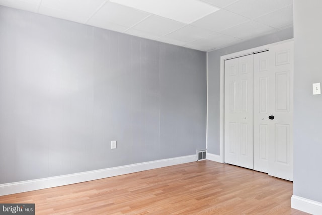 4018 Pennington Ave, Baltimore City, MD 21226 - unfurnished bedroom with visible vents, a closet, baseboards, light wood-style floors, and a drop ceiling
