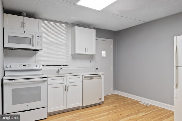4018 Pennington Ave, Baltimore City, MD 21226 - kitchen with visible vents, baseboards, light wood finished floors, white appliances, and white cabinetry