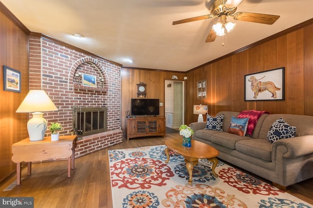 5983 Labs Run Ln, Penn Laird, VA 22846 - living room with ornamental molding, wood walls, hardwood / wood-style floors, a fireplace, and a ceiling fan