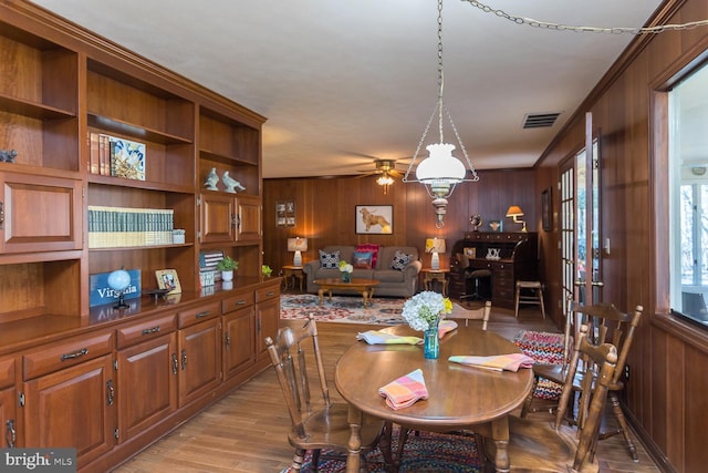 5983 Labs Run Ln, Penn Laird, VA 22846 - dining room with a ceiling fan, wood walls, light wood finished floors, and visible vents