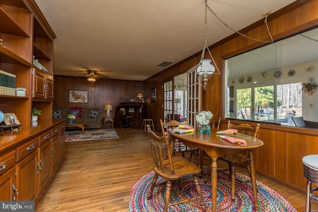 5983 Labs Run Ln, Penn Laird, VA 22846 - dining space featuring visible vents, light wood-style floors, ceiling fan, and wooden walls