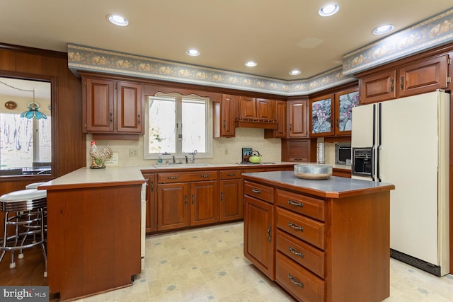 5983 Labs Run Ln, Penn Laird, VA 22846 - kitchen featuring a sink, white appliances, a peninsula, recessed lighting, and a kitchen island