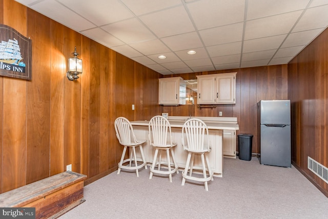 5983 Labs Run Ln, Penn Laird, VA 22846 - kitchen featuring freestanding refrigerator, wooden walls, light colored carpet, and a drop ceiling