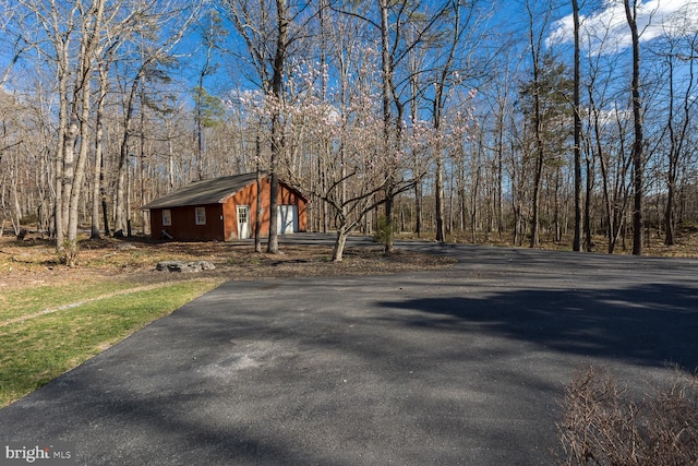 5983 Labs Run Ln, Penn Laird, VA 22846 - exterior space with a detached garage, a wooded view, an outdoor structure, and aphalt driveway