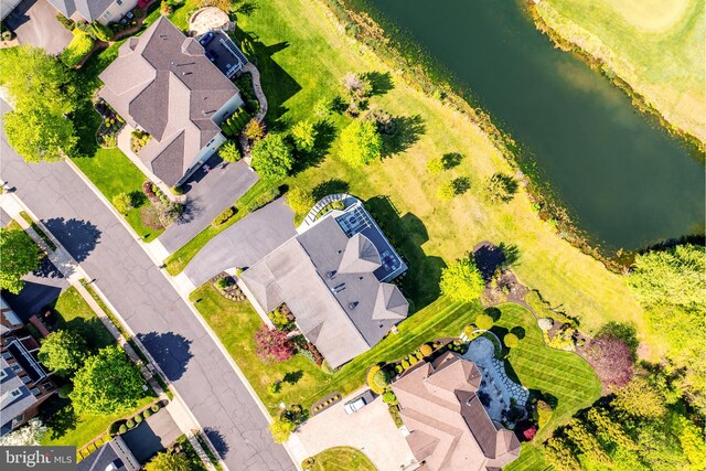 birds eye view of property featuring a water view and a residential view