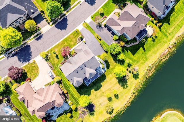 birds eye view of property with a water view and a residential view