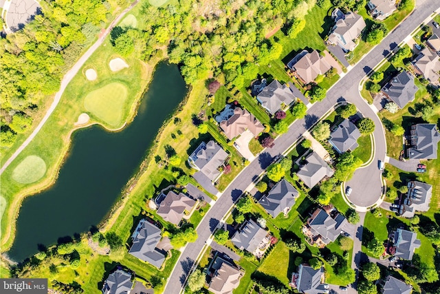 birds eye view of property with a water view and a residential view
