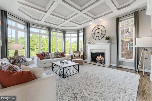 living room with a high end fireplace, baseboards, coffered ceiling, and wood finished floors