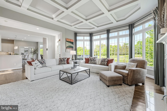 living area featuring beamed ceiling, coffered ceiling, recessed lighting, and wood finished floors