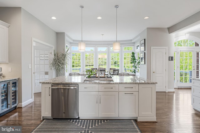 kitchen with light stone countertops, white cabinetry, wine cooler, stainless steel dishwasher, and dark wood-style floors