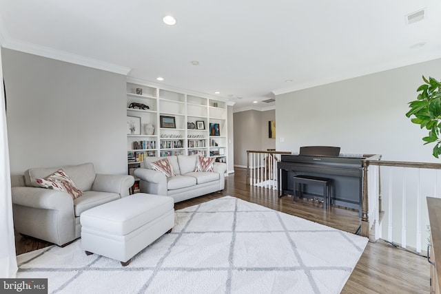 living room with visible vents, ornamental molding, wood finished floors, and recessed lighting