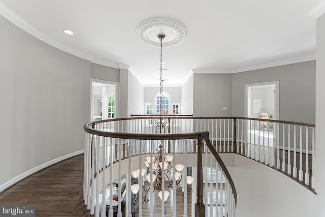 hallway featuring an inviting chandelier, recessed lighting, an upstairs landing, wood finished floors, and ornamental molding