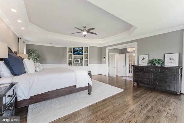 bedroom featuring crown molding, recessed lighting, a raised ceiling, and wood finished floors