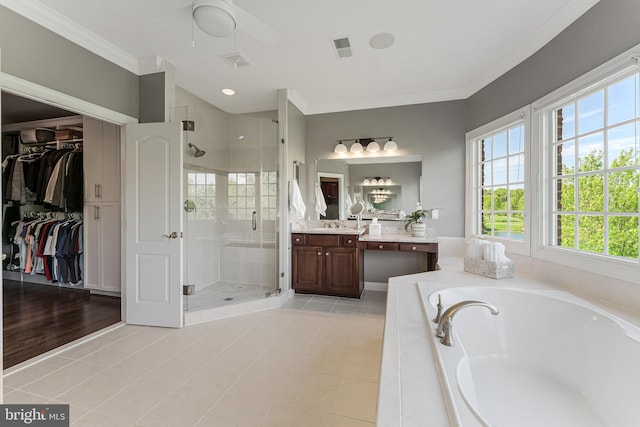 full bathroom featuring a bath, visible vents, crown molding, a shower stall, and vanity