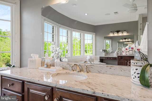 bathroom with crown molding, ceiling fan, visible vents, and vanity