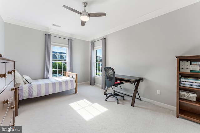 carpeted bedroom with visible vents, a ceiling fan, baseboards, and crown molding