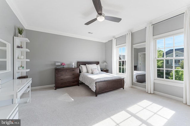bedroom featuring carpet, a ceiling fan, baseboards, visible vents, and ornamental molding