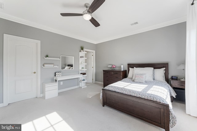 carpeted bedroom featuring baseboards, ornamental molding, a ceiling fan, and visible vents