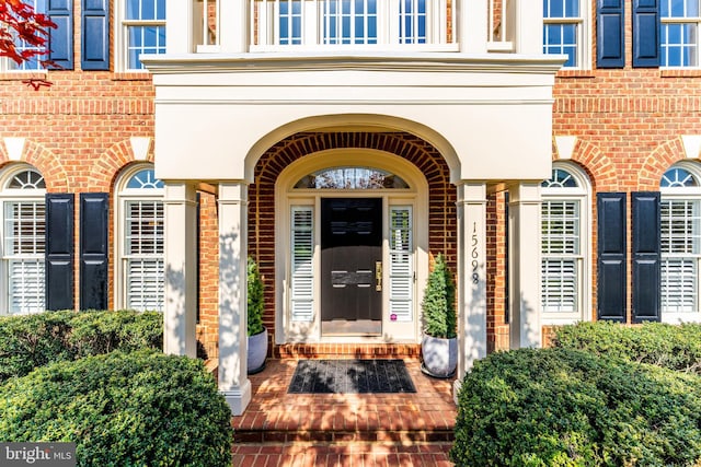 property entrance with brick siding