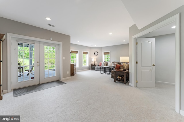 sitting room with visible vents, baseboards, recessed lighting, french doors, and carpet