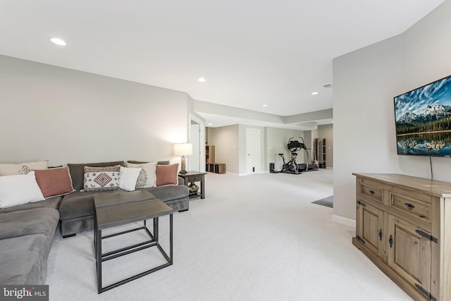 living area featuring baseboards, light carpet, and recessed lighting