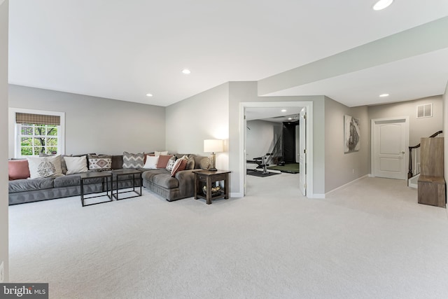 living area featuring recessed lighting, baseboards, light carpet, and stairway