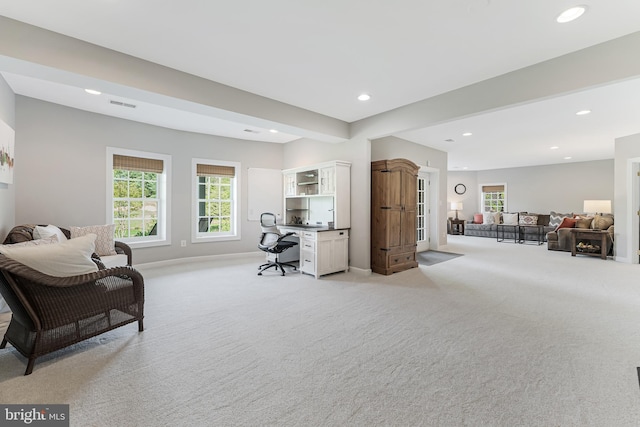 office space with recessed lighting, baseboards, visible vents, and light carpet